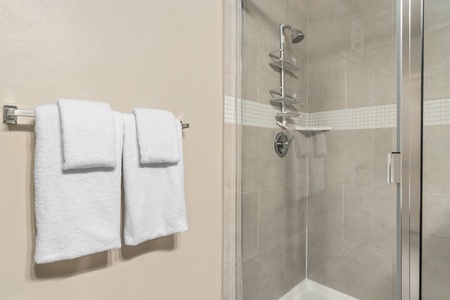 Experience a revitalizing shower in the walk-in shower with modern fixtures.