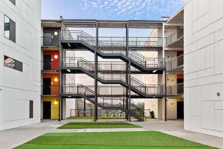 Apartment access is via open-air, covered hallways in an Austin-style design; these corridors are not climate-controlled and may be exposed to outdoor weather.