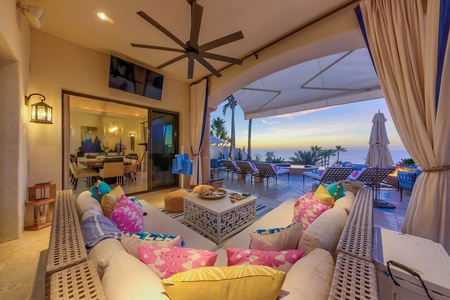 View of the open seating area next to the dining room with open access to the pool and patio.