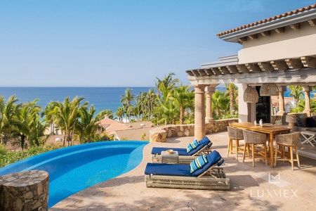 The pool and patio space of Casita 6, with blue chairs by the side.