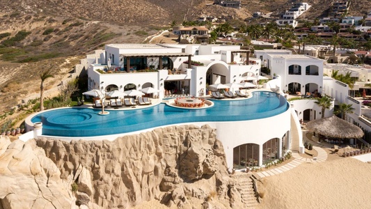 The front exterior of La Datcha, one of our luxury Los Cabos Beachfront villas, as seen from the air.