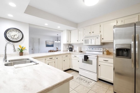 Fully stocked kitchen with cups~ plates~ utensils