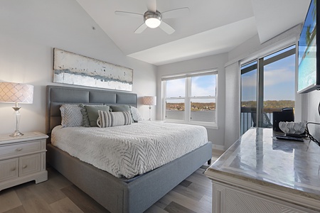Drift off to sleep in your elegant bedroom, where soft linens meet stunning views through floor-to-ceiling windows.