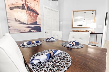 Gather around your elegant dining table, beautifully set with nautical touches and maritime artwork creating the perfect atmosphere for memorable meals.