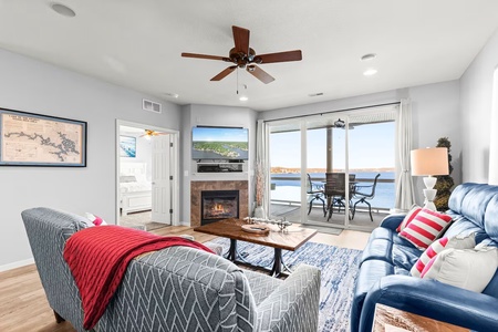 Relax in your cozy living space with a crackling fireplace and stunning water views from your private balcony.