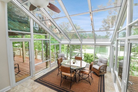 Beautiful sunroom overlooking the lake. Outdoor patios on each side.