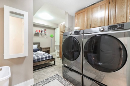 Laundry room and twin bed for additional guests.
