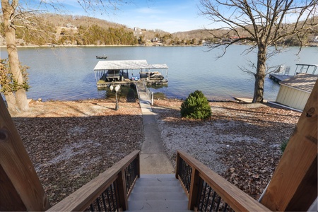 Private lake access with boat dock stretches directly from the property, offering serene water views and peaceful surroundings.