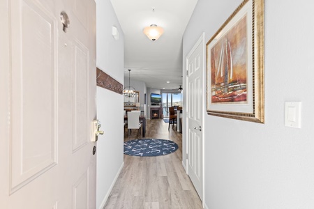 Step into your elegant hallway with beautiful artwork and glimpses of the inviting living spaces beyond.