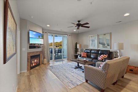 Unwind in your spacious living room with cozy fireplace, modern entertainment system, and sliding doors to your private balcony.