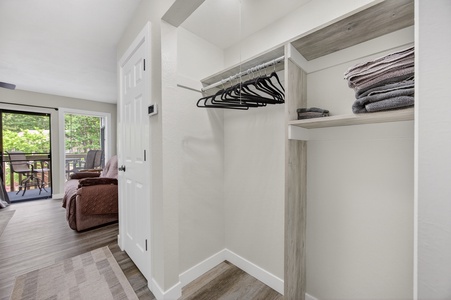 A spacious walk-in wardrobe awaits your belongings, with ample hanging space and shelving for easy organization during your stay.