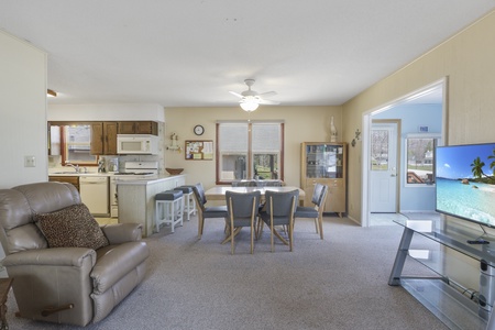 Settle into your spacious open-plan retreat with a fully equipped kitchen, cozy dining space, and entertainment center for perfect vacation comfort.