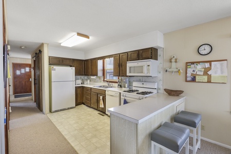 Your fully equipped kitchen features everything you need for home-cooked meals, with a convenient breakfast bar perfect for morning coffee.
