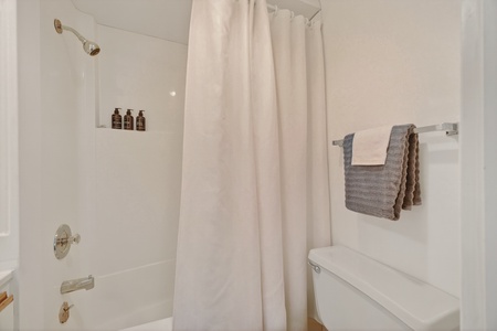 Unwind in your pristine bathroom with a refreshing shower, fluffy towels at the ready, and luxurious toiletries waiting for you.