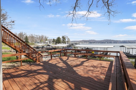Spacious lakefront deck with panoramic water views, perfect for morning coffee or evening relaxation overlooking the peaceful marina.