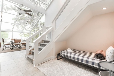 Twin bed under the staircase.