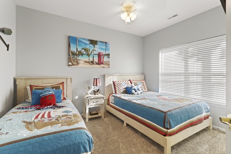 Drift off to sweet dreams in this coastal-themed bedroom where twin beds offer comfort for young travelers or friends.