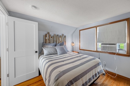 Unwind in your cozy bedroom with warm wood tones and coastal charm. Thoughtfully designed for restful nights with soft linens and modern comfort.