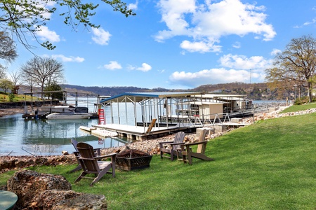 Waterfront marina with private boat docks and covered slips on a scenic lake surrounded by rolling hills.