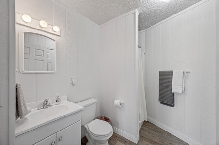Freshen up in your bright, clean bathroom with a vanity, mirror with Hollywood-style lighting, and a spacious walk-in shower awaiting you.