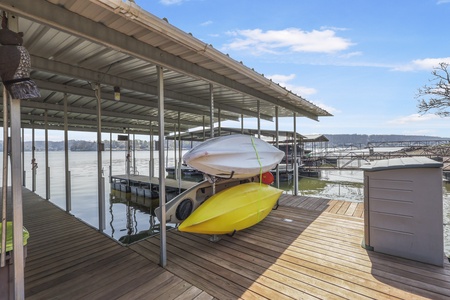 Your private dock awaits with kayaks ready for lake adventures and covered boat slip for endless water fun.