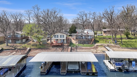 Waterfront retreat with private boat slips and lakeside setting, surrounded by peaceful residential community.