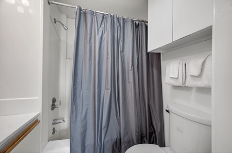 Step into your spotless bathroom where fresh towels await and a spacious tub-shower combo promises refreshing mornings and soothing evenings after exploring.