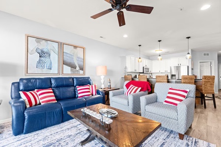 Unwind in your stylish living space featuring a plush navy sofa and modern amenities, perfectly designed for coastal relaxation.