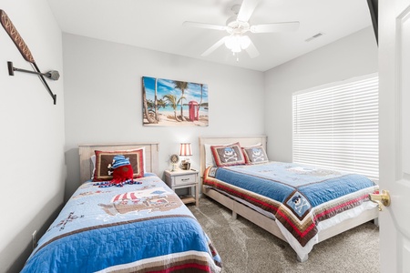 Your little adventurers will love this charming pirate-themed bedroom with twin beds and whimsical nautical décor.