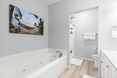 Unwind in your private spa-like bathroom featuring a jetted tub and tropical artwork that transports you to paradise.