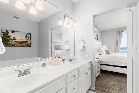 Your bright ensuite bathroom features dual sinks and connects to your bedroom with lovely views.