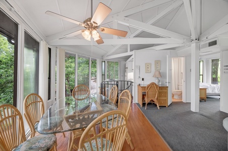 Your bright, open-plan retreat features vaulted ceilings, a cozy dining space for six, and garden views through expansive windows that bring the outdoors in.