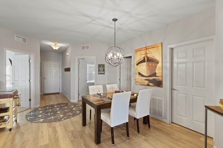 Your elegant dining space features a stylish table for six under a stunning pendant light, perfect for memorable meals together.