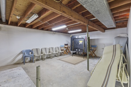 Your basement entertainment space features exposed beam ceilings, flexible seating, and room for activities.
