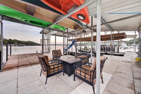 Settle into your private dock with lake views, kayaks ready overhead, and cozy seating for waterfront relaxation. Your perfect retreat awaits on the water.