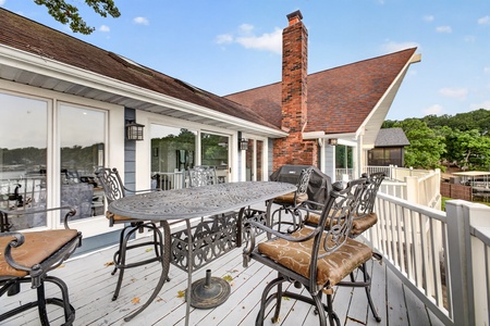 Your spacious lakeside deck awaits, complete with elegant dining seating and a built-in grill, perfect for sunset barbecues and memorable gatherings with loved ones.
