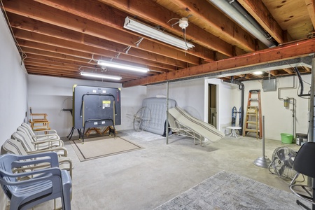 Store your belongings and beach gear in this spacious basement storage area with exposed beam ceilings and concrete floors.