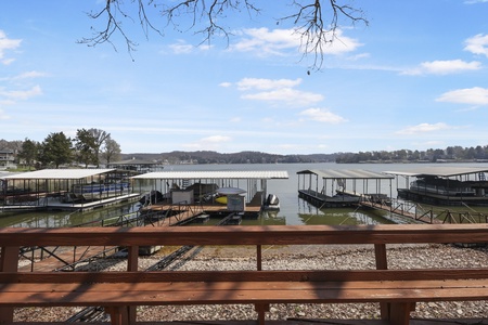 Peaceful lake marina with boat slips and rolling hills creating a serene waterfront setting.