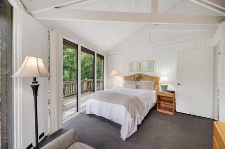 Wake up to leafy green views from your private balcony in this peaceful bedroom retreat, where vaulted ceilings and soft linens create the perfect space to unwind and recharge.