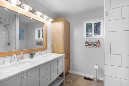 Step into your beautifully updated bathroom with dual sinks, modern fixtures, and a spacious shower—perfect for refreshing mornings or unwinding after mountain adventures.