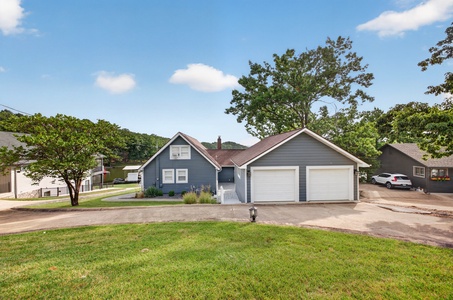 A welcoming vacation rental surrounded by mature trees and peaceful residential streets, with ample parking in the two-car garage.