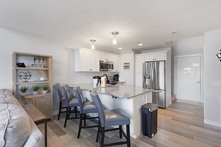 Your modern kitchen awaits with granite counters, stainless steel appliances, and stylish bar seating for memorable meals.