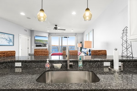 Your kitchen offers stunning sea views while you prepare meals, with granite countertops and modern fixtures creating the perfect cooking space.