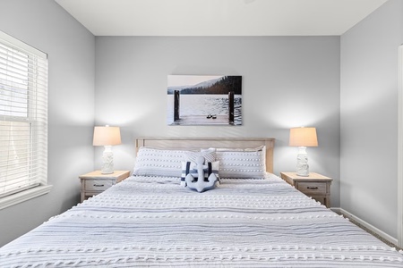 Sink into this serene bedroom where soft linens and warm bedside lighting create your perfect retreat after exploring.