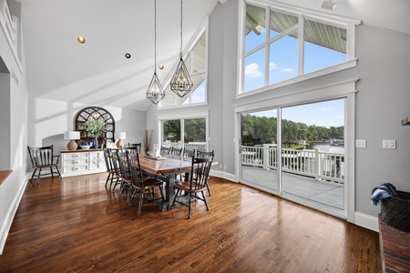 Soaring vaulted ceilings and sunlight fill the dining area. Step onto the private deck for waterfront views—perfect for morning coffee or evening relaxation.