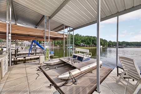 Your private covered dock awaits, complete with a boat slide, loungers, and sweeping lake views—perfect for sun-soaked afternoons and easy water access.
