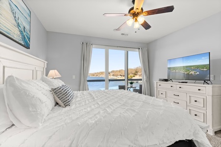 Wake up to stunning lake views from your plush bedroom, where crisp linens and gentle ceiling fan breezes create the perfect morning retreat.