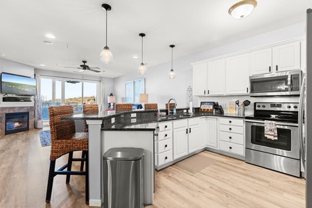 Your fully-equipped kitchen welcomes you with granite countertops, stainless steel appliances, and an inviting breakfast bar perfect for morning coffee.