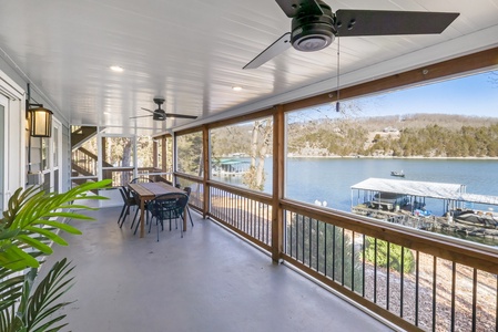 Your screened-in porch offers breathtaking lake views where you can dine al fresco while watching boats drift by on peaceful waters.