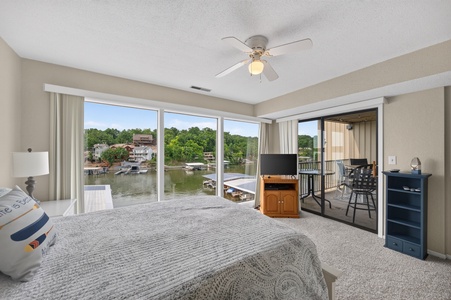 Your bedroom opens to waterfront views of the marina, docks, and lush tree-lined shores. Relax on your private balcony with direct access to serene lake vistas.
